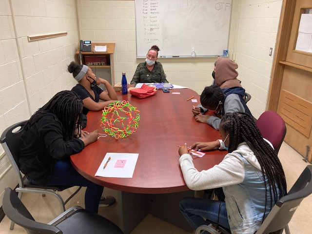 A group of students sitting around a table 