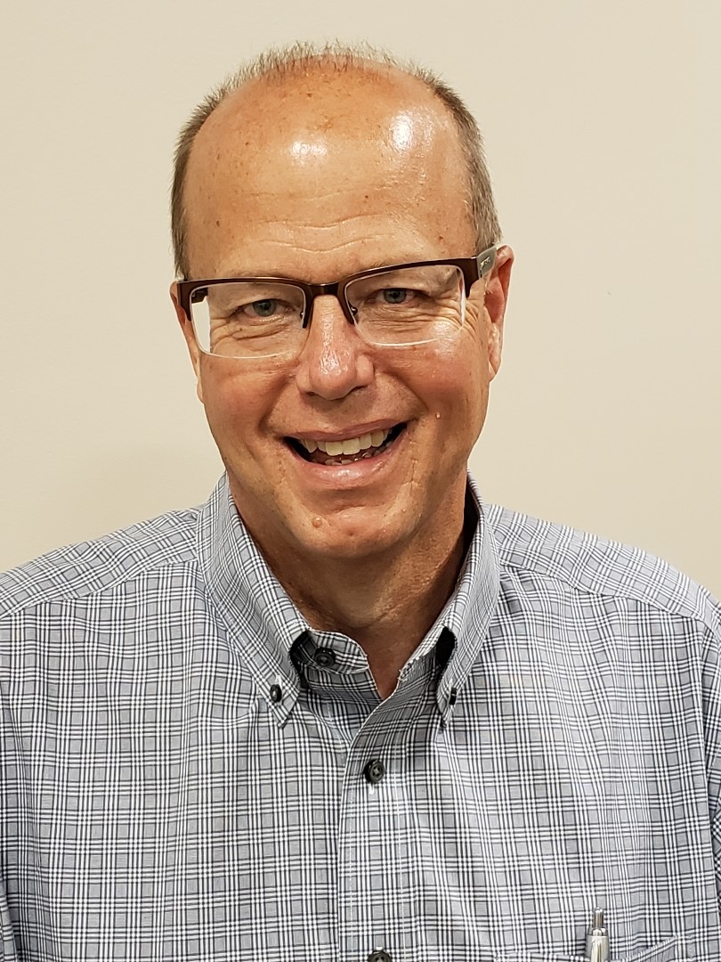 Pat Bohon, a person with glasses and sparse gray hair, smiles.