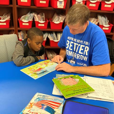 SOH tutor reading with a student