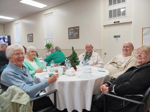 older people seated around a table