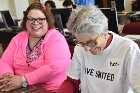 A VITA volunteer helps a person with their taxes.