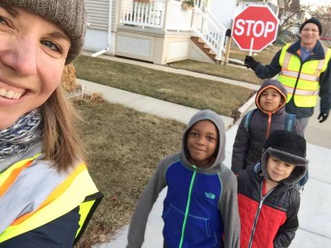 A Walking School Bus conductor walks with the students.