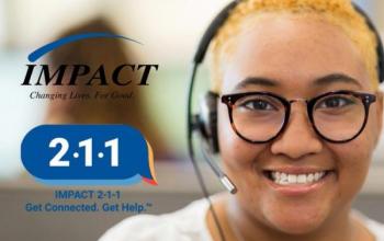 A person with round, tortoise-shell glasses, medium-dark skin and tight, curly blond hair wears a headset with an earpiece and microphone. They grin at the camera. Beside their face are the Impact logo, which says "Changing Lives. For Good," and the 211 logo, which says "Impact 2-1-1. Get connected. Get help."