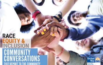 The cover of United Way of Racine County's 2017 Community Conversations Report, entitled "Race, Equity & Inclusion: Community Conversations 2017 Report to the Community." This text displays over a photo of mixed race individuals standing in a circle and joining hands in the center.