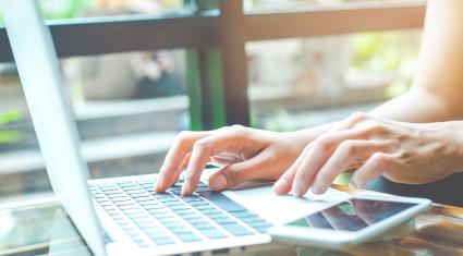hands working on a laptop